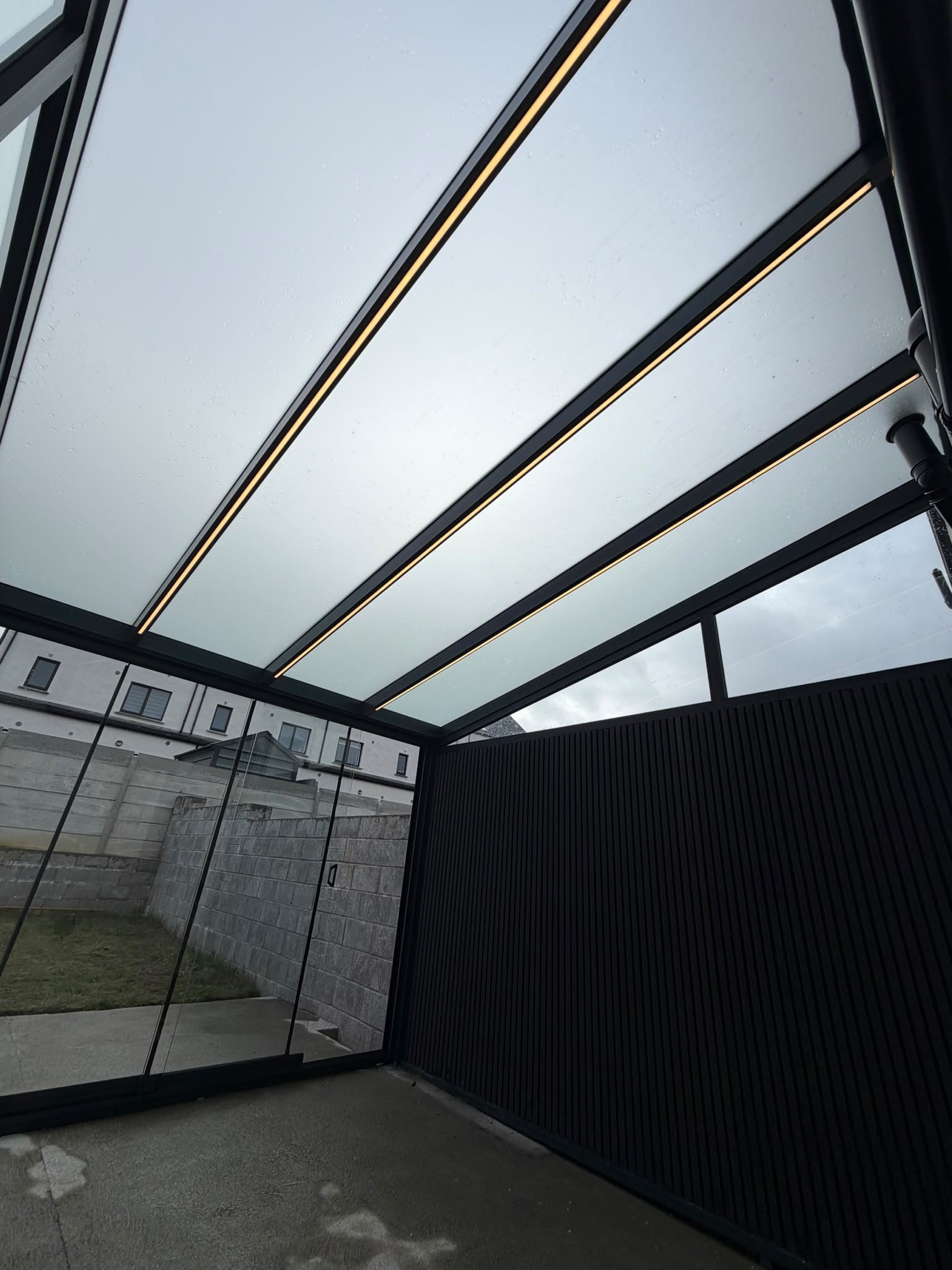 LED strips built into the roof beams of a pergola veranda
