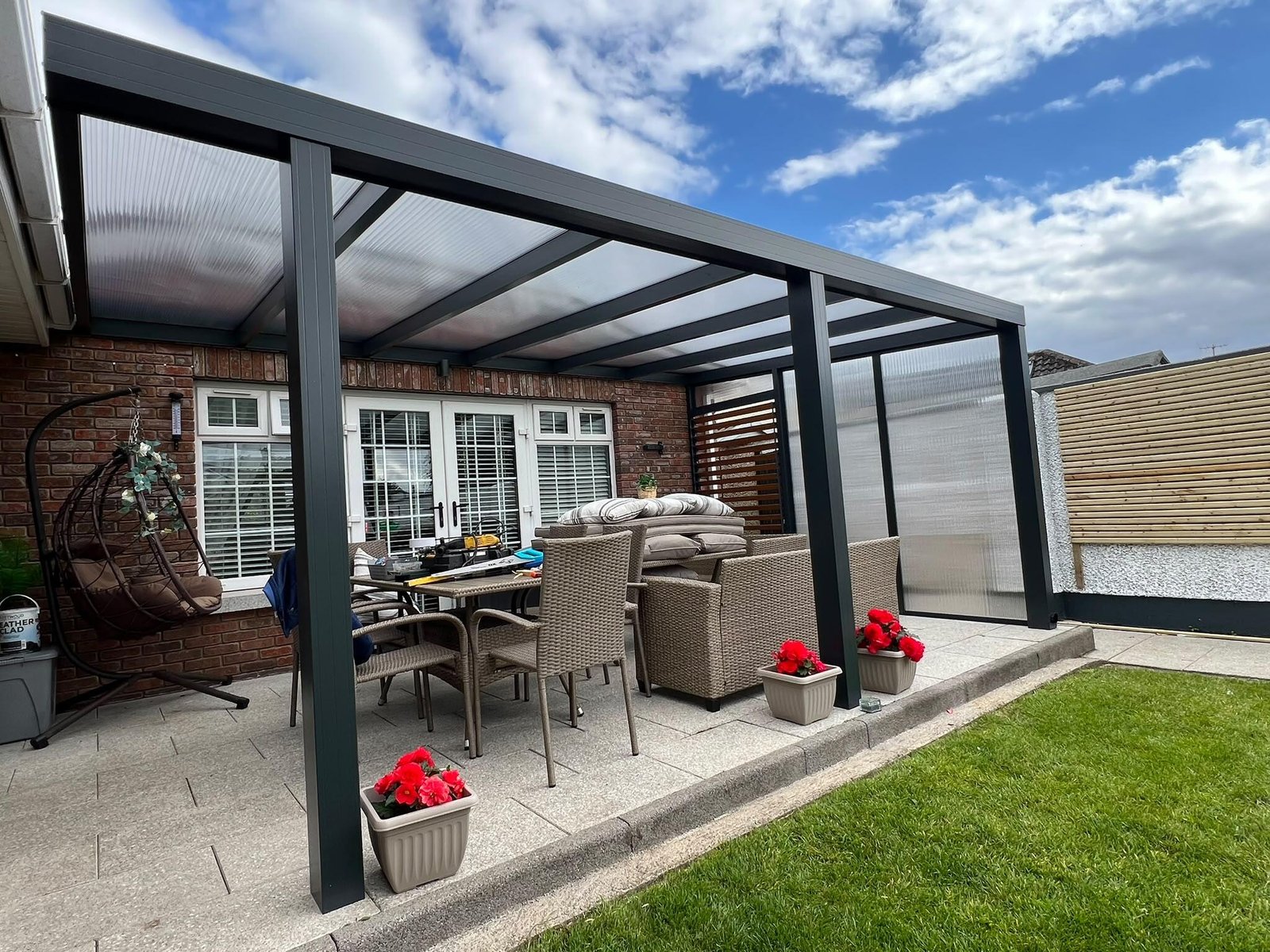 Aluminium pergola veranda with a polycarbonate roof over a patio