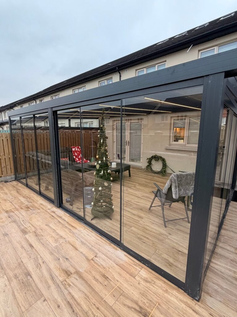 Aluminium pergola veranda with a glass roof fitted to the rear of a house