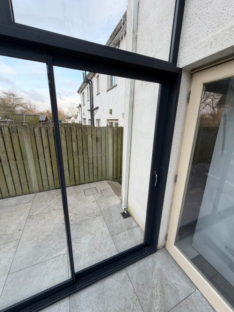 Fully glazed aluminium veranda with sliding glass walls
