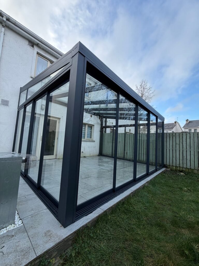 Glass roof veranda with sliding glass walls at the back of a house in Carlow